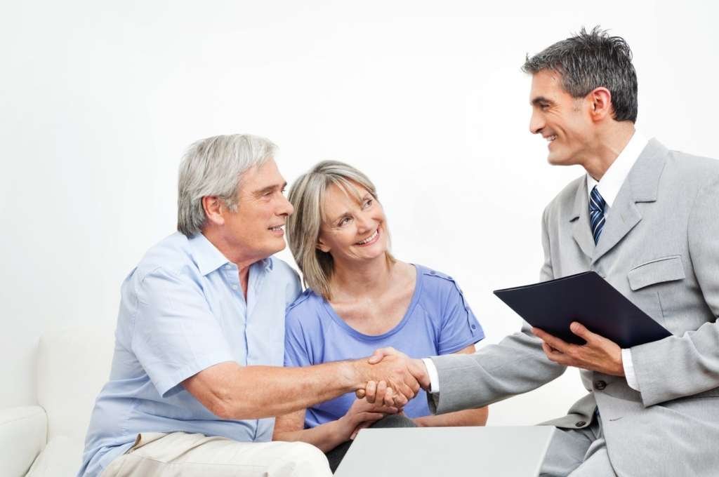 man shaking couples hands