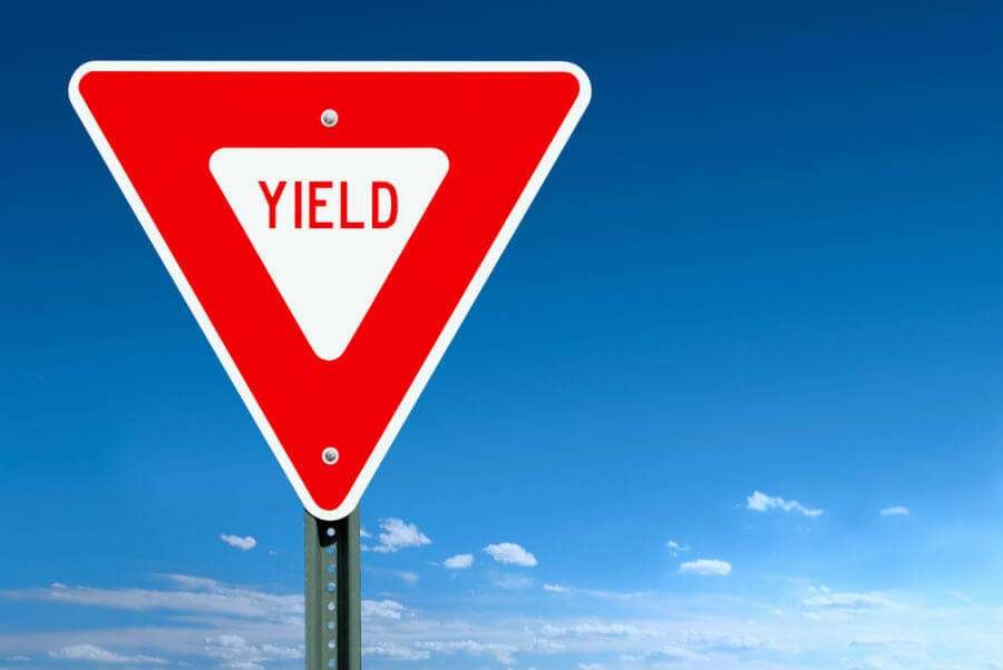 Road sign with term "yield" printed on it