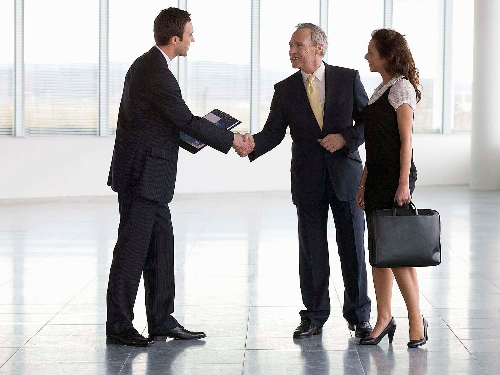 commercial property agent greeting business man and business woman
